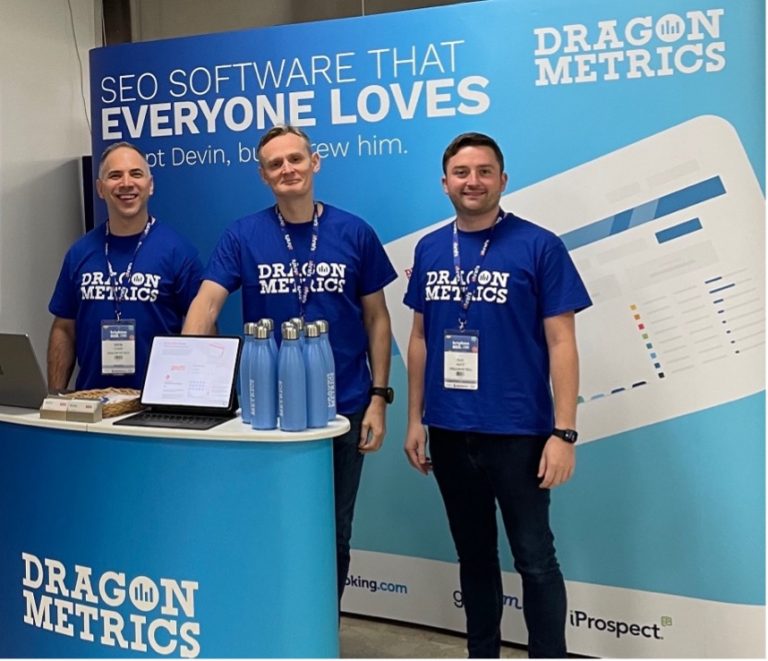 Dragon Metrics team (Simon, Richard and Marc) at their branded booth at BrightonSEO